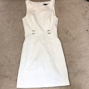 This is a White House black market dress in the color white with no sleeves.
